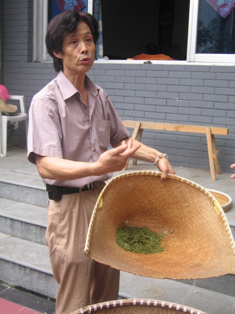 The tea master explaining the drying process
